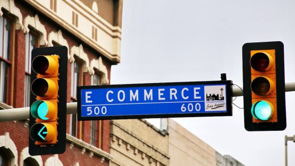 E-commerce - a traffic light with a street sign hanging from it's side