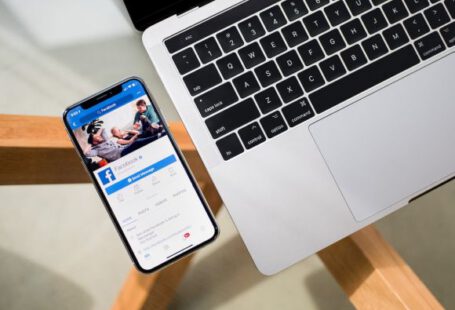 Facebook - iPhone X beside MacBook
