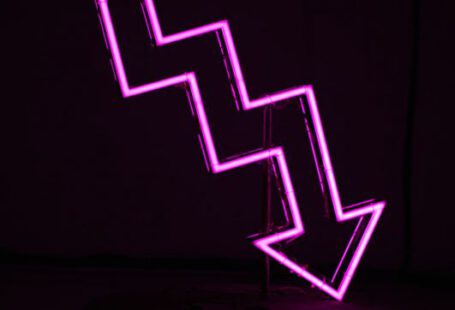 Downward - pink arrow neon sign