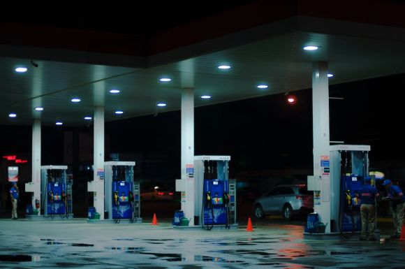 Petrol - person taking a photo of blue and white gasoline station