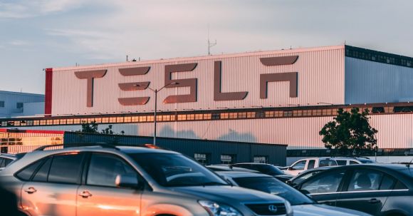 Tesla Soars - Cars Parked In Front Of Company Building
